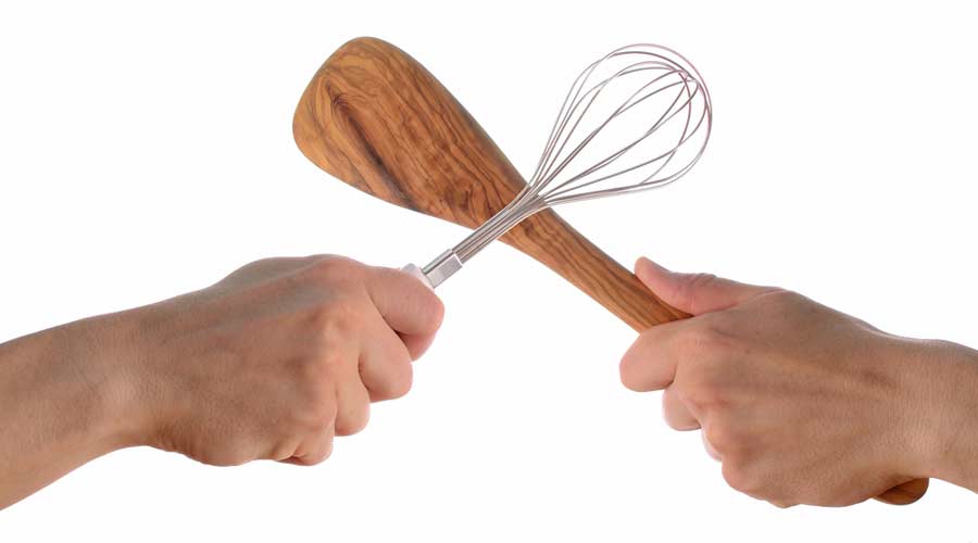 Dueling hands with cooking utensils