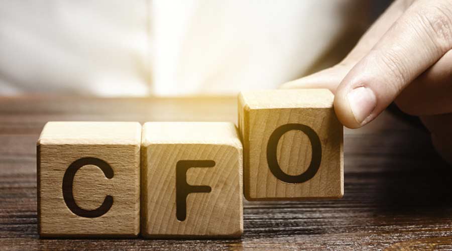A man makes the word acronym abbreviation CFO. Chief Financial Officer. Financial management in business and company. Risk. Development and growth. Appointment to a new post, promotion.