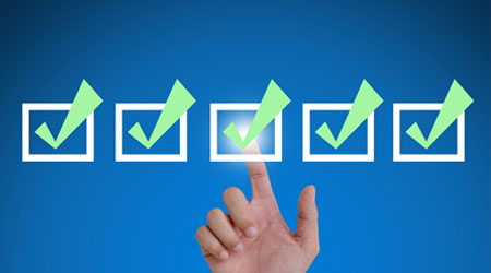 hand pointing a mark the check boxes. on a touch screen interface.