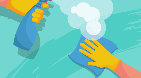 Surface cleaning in house. Spraying antibacterial sanitizing spray. Prevention coronavirus COVID-19. Bottle of disinfection and a rag in the hands of a cleaner. Medical blue gloves. Sanitize surfaces.