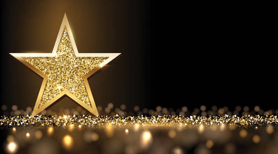 Golden sparkling star isolated on dark luxury horizontal background. Vector design element