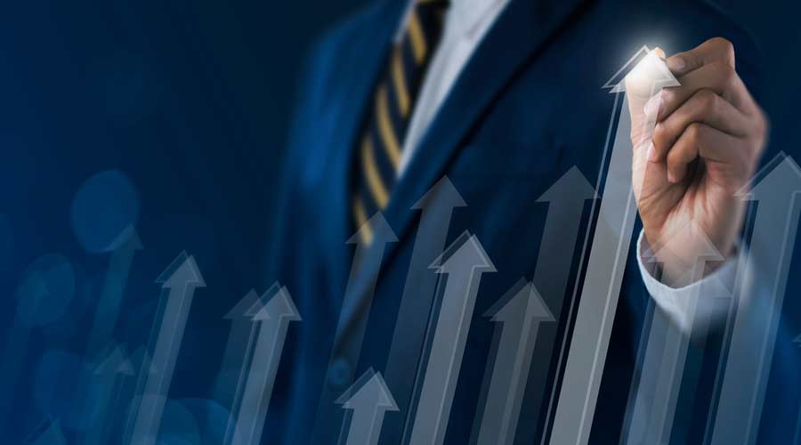 Business growth, boost up business, progress in business or success concept. Businessman is drawing raising arrow graph on dark tone background.