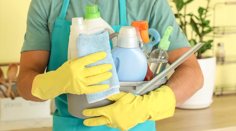 holding bottles of cleaning detergent