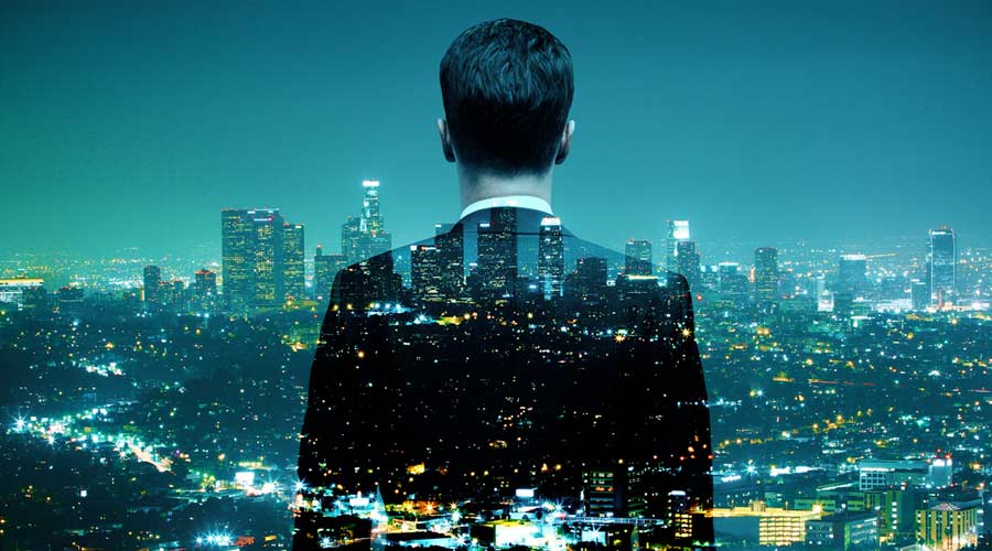 Businessman looking at illuminated night city. Double exposure