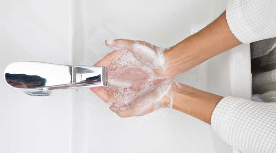 washing hands in sink