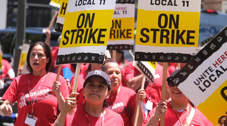 Striking hotel workers holding signs rally outside the Intercontinental Los Angeles Downtown on Monday, July 3, 2023, in Los Angeles.