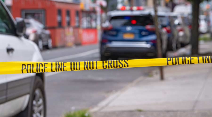 NEW YORK, NY – AUGUST 01, 2021: New York Police Department (NYPD) investigate following a gang-related nighttime shooting that injured 10 people on 37 Avenue in Corona, Queens.
