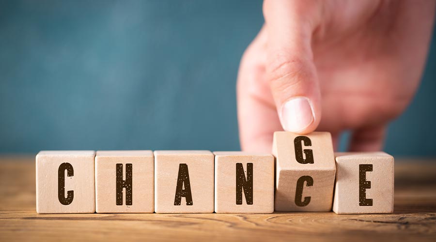 hand flipping one of six cubes, turning the word "change" to "chance"