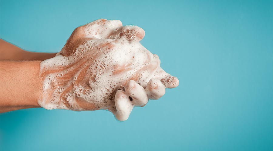 Closeup of person washing hands isolated. Cleanliness and body care concept