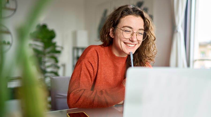young woman laughing while working from home