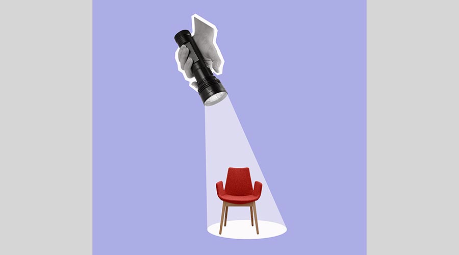 A hand holds a flashlight on an office chair. Contemporary art collage. Hiring and recruitment concept.