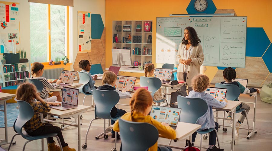 Teacher Educating Smart Diverse Kids in a Modern Colorful Classroom