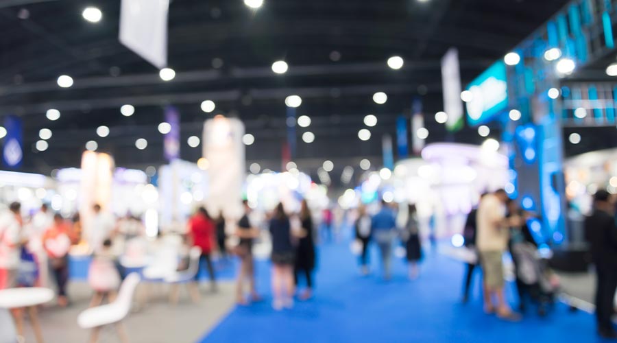 Abstract blur people in exhibition hall event trade show expo background. Large international exhibition, convention center, business marketing and event fair organizer concept