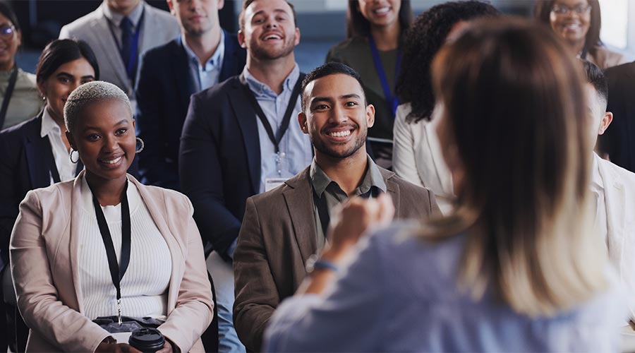 Audience, conference and business people listening to speaker at a seminar, workshop or training. Diversity men and women crowd at a presentation for learning, knowledge and corporate discussion