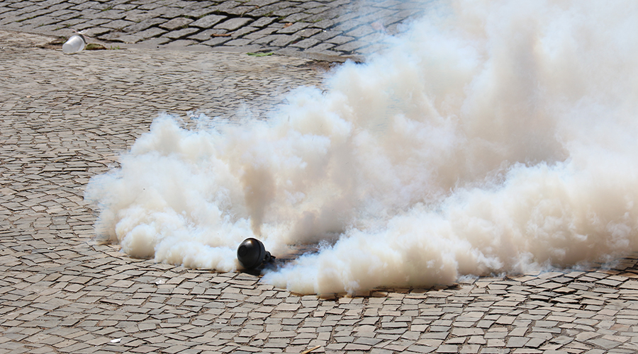 Tear gas bomb exploding on the floor.