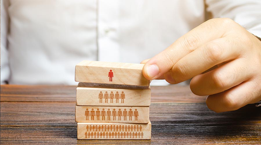 Businessman is building a hierarchy in a company. Leadership, teamwork, feedback in the team. Cooperation, collaboration. Appointment of loyal people to leadership positions. Discipline and order