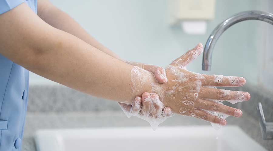 Hygiene and cleaning hands.Washing hands rubbing with soap for corona virus prevention, hygiene to stop spreading coronavirus.Close up woman hand washing in the kitchen.