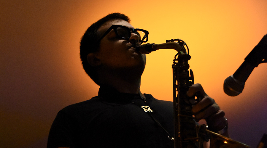 David Mirarchi, sales rep for RJ Schinner, playing saxophone with backlit glow