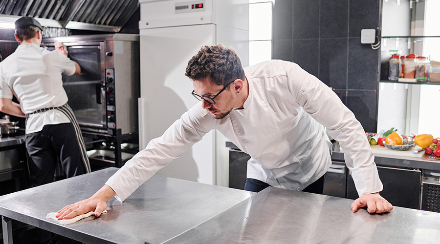 Staff cleaning kitchen after work