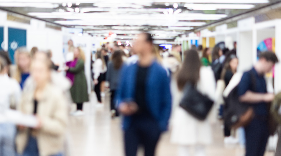 Abstract blurred people at exhibition hall of expo event trade show. Business convention show or job fair. Business concept background.