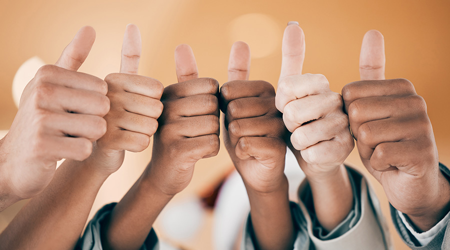 Business people, hands and thumbs up for thank you, good job and welcome gesture for recruitment in office. Corporate group, team building and community vote for hiring, victory and achievement